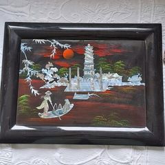 Vintage Vietnamese black lacquer wall plaque featuring intricate mother-of-pearl inlay.