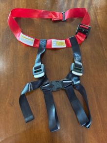 Child safety restraint for airplane