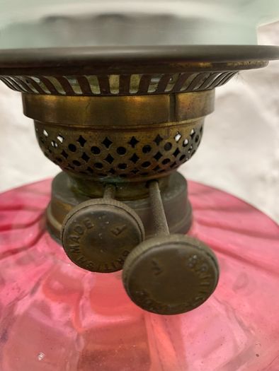 Early Edwardian oil lamp with cast metal base.