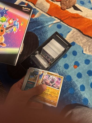 pokemon cards and book and sleeves and game thing