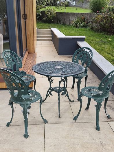 Cast metal garden table and four chairs