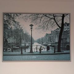 Two framed city pictures of Paris and Amsterdam