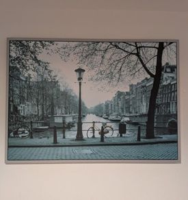 Two framed city pictures of Paris and Amsterdam