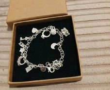 Heavy silver plated charm bracelet 11 charms on it