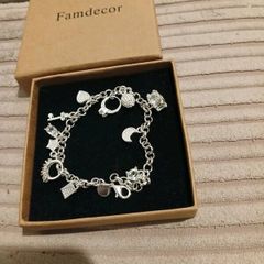 Heavy silver plated charm bracelet 11 charms on it