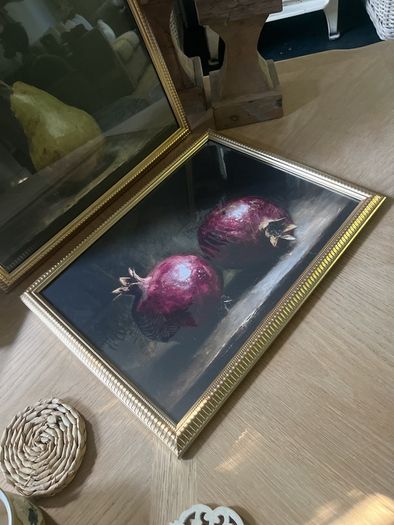 Two gold framed fruit prints.
