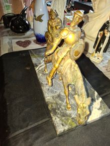 Rare Don Quixote and Sancho Panza cast in patinated bronze and mounted onto a veined marble plinth base. Don Quixote is depicted atop his gaunt horse, Rocinante, holding his shield, while his squire Sancho Panza follows