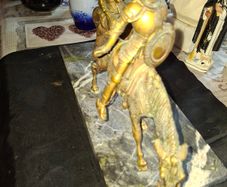 Rare Don Quixote and Sancho Panza cast in patinated bronze and mounted onto a veined marble plinth base. Don Quixote is depicted atop his gaunt horse, Rocinante, holding his shield, while his squire Sancho Panza follows