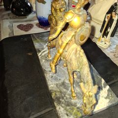 Rare Don Quixote and Sancho Panza cast in patinated bronze and mounted onto a veined marble plinth base. Don Quixote is depicted atop his gaunt horse, Rocinante, holding his shield, while his squire Sancho Panza follows