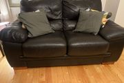 Two seater black leather couch for sale. Basically never used. Same condition as new.