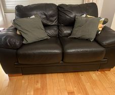 Two seater black leather couch for sale. Basically never used. Same condition as new.
