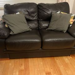 Two seater black leather couch for sale. Basically never used. Same condition as new.