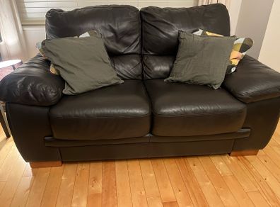 Two seater black leather couch for sale. Basically never used. Same condition as new.