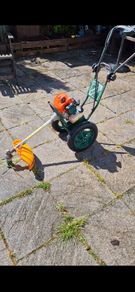 Rufcut grass trimmer on wheels.