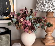 Faux flowers in stone vase