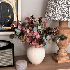 Faux flowers in stone vase