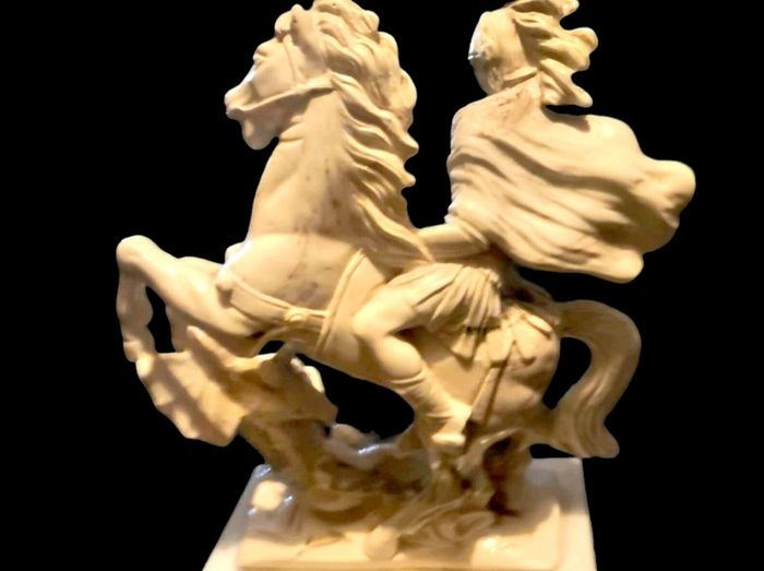 Heavy statue on white marble base