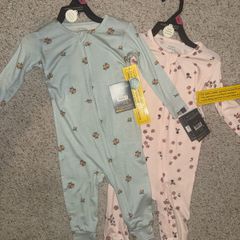 Bamboo style zip baby sleep suits.