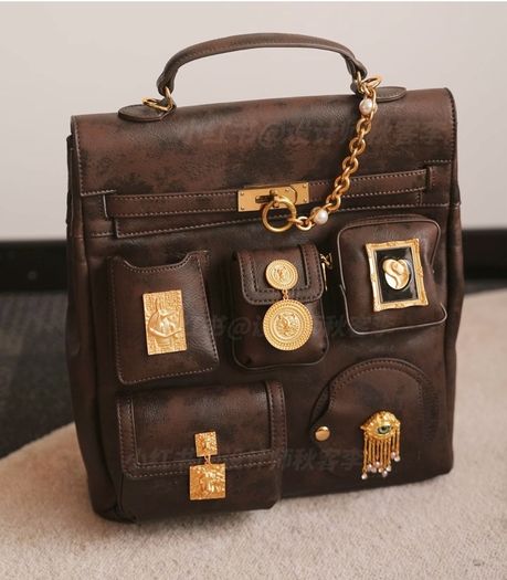 Vintage inspired dark brown backpack with antique gold details