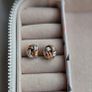 Beautiful silver and rose gold-tone knot stud earrings. Image 2