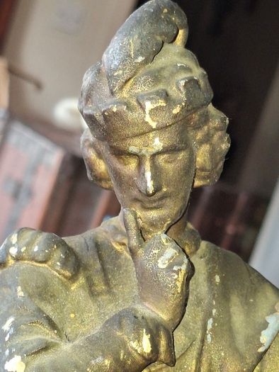 Antique Sculpture a gilt-bronze cast-metal Spanish Conquistador. On his torso is a Cross Pattee, a historical motif commonly associated with Christian military orders and medieval heraldry