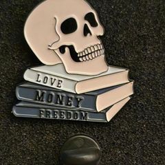 Skull and books , pin back badge.