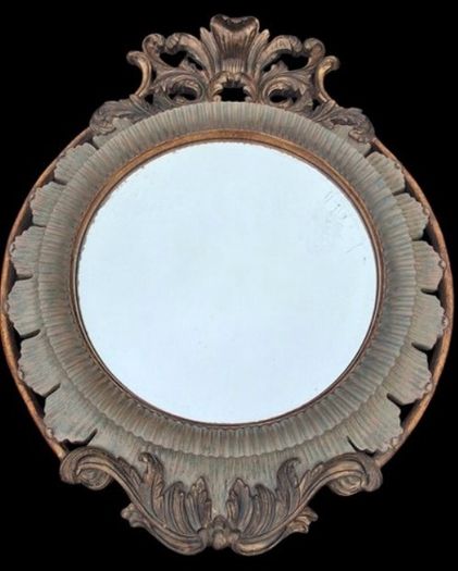 Large bevel edged mirror with ornate moulded frame.