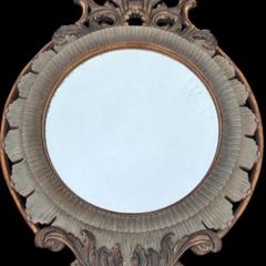 Large bevel edged mirror with ornate moulded frame.
