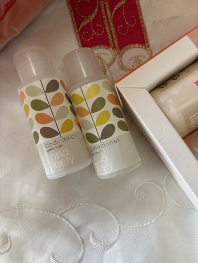 A Bundle of Orla Kiely Products - Bergamot Mini bath and hand set , a pull string wash bag, 2 empty body lotion and conditioner and a limited edition travel porcelain cup for Kenco