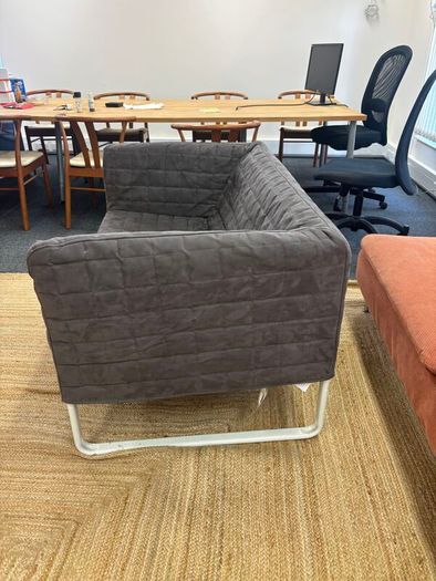 Grey quilted sofa with white metal frame