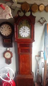grandfather clock and wall clocks