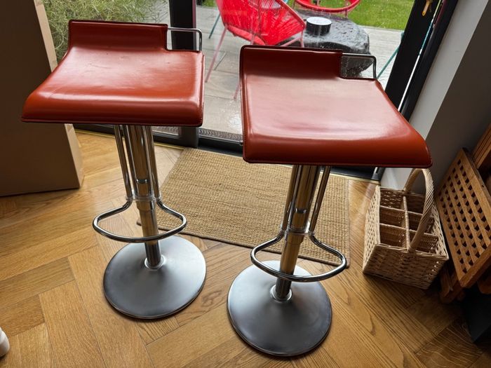 Vintage Italian orange leather bar stools.