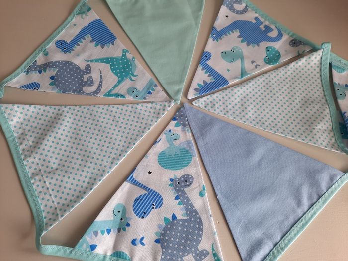 Dinosaur buntings . Blue and pink