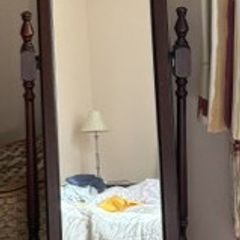 Freestanding cheval mirror with storage drawer