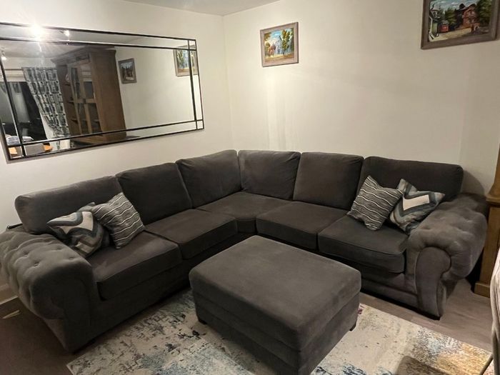 Grey corner sofa with matching footstool