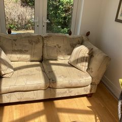 Double sofa, cushions and a throw