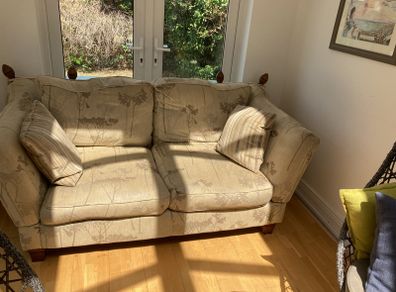 Double sofa, cushions and a throw