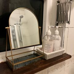 Mirror and set of restroom bottles