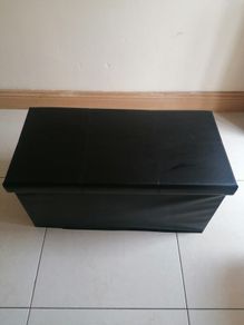 Black faux-leather folding storage ottoman
