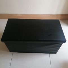 Black faux-leather folding storage ottoman