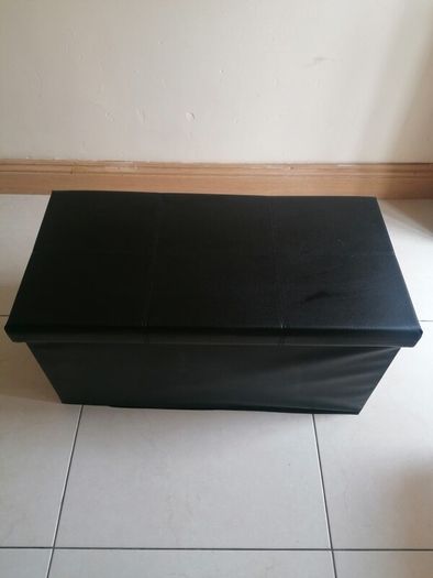 Black faux-leather folding storage ottoman