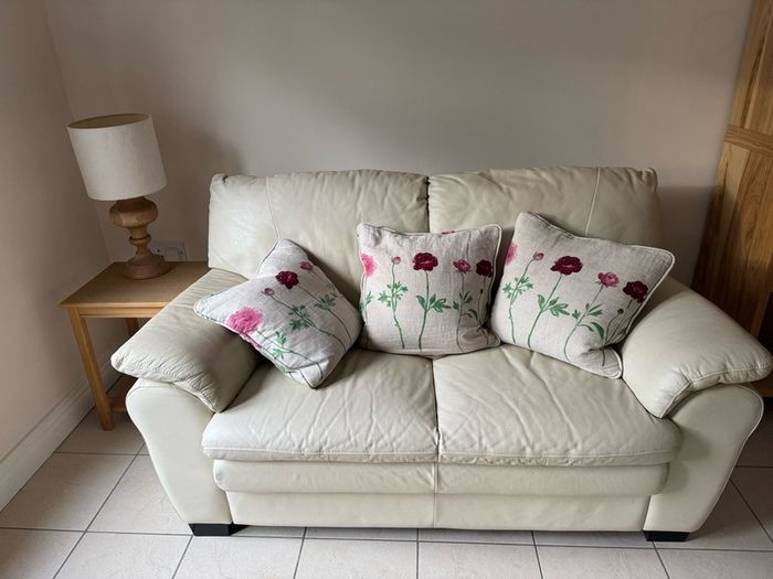 Cream leather two seater sofa