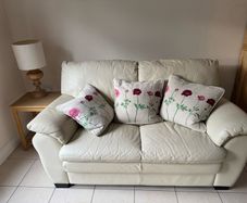 Cream leather two seater sofa
