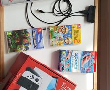 nintentendo switch with lots of games and sports pack accessories