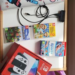 nintentendo switch with lots of games and sports pack accessories
