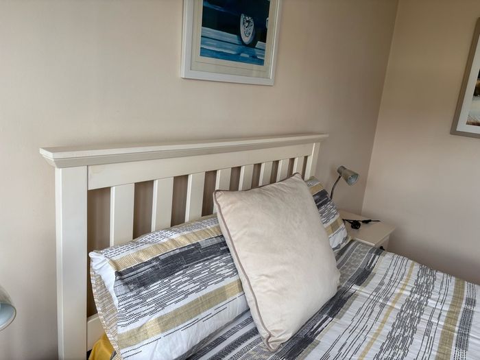 Cream wooden double bed