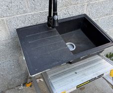 Composite kitchen sink with tap