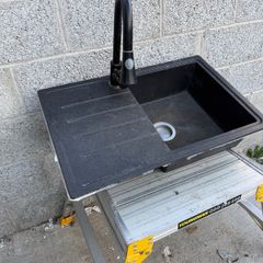 Composite kitchen sink with tap