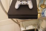 Playstation 4 slim with controller.