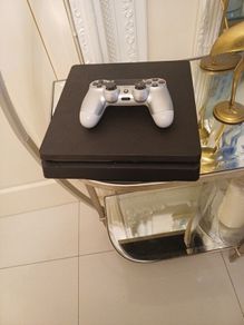 Playstation 4 slim with controller.